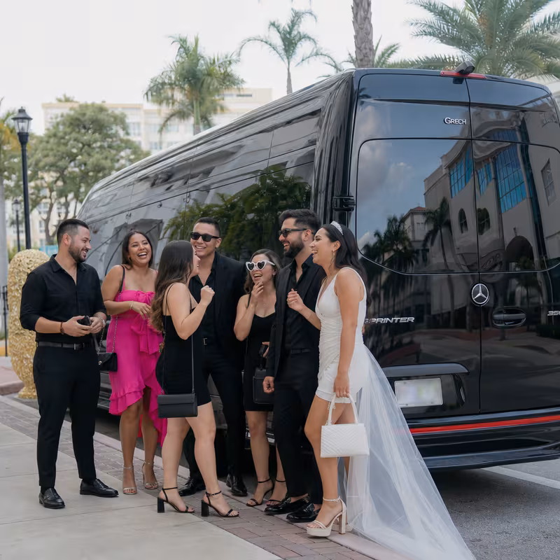 Group boarding a white charter bus for Bachelor & Bachelorette Transportation transportation in Pembroke Pines