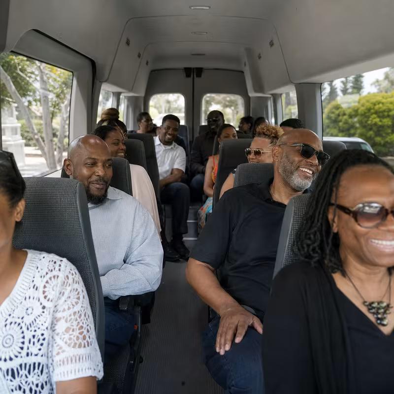Group boarding a white charter bus for Private Event Transportation transportation in Pembroke Pines