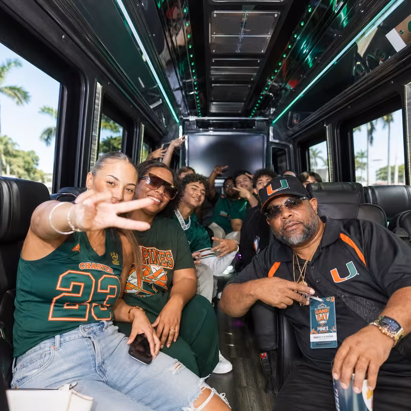 Group boarding a white charter bus for Sporting Event Transportation transportation in Pembroke Pines